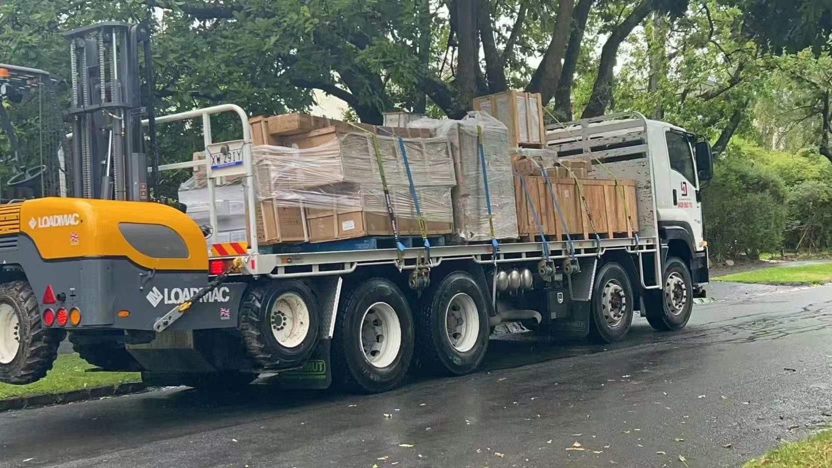 Packaged furniture on a delivery truck with a mounted forklift in Australia